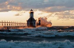 water hitting lighthouse
